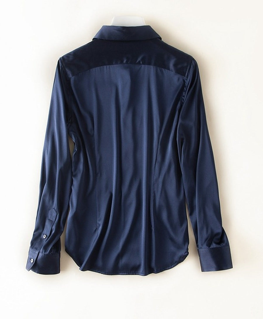 The back of the navy shirt, showing the yoke and curved hem