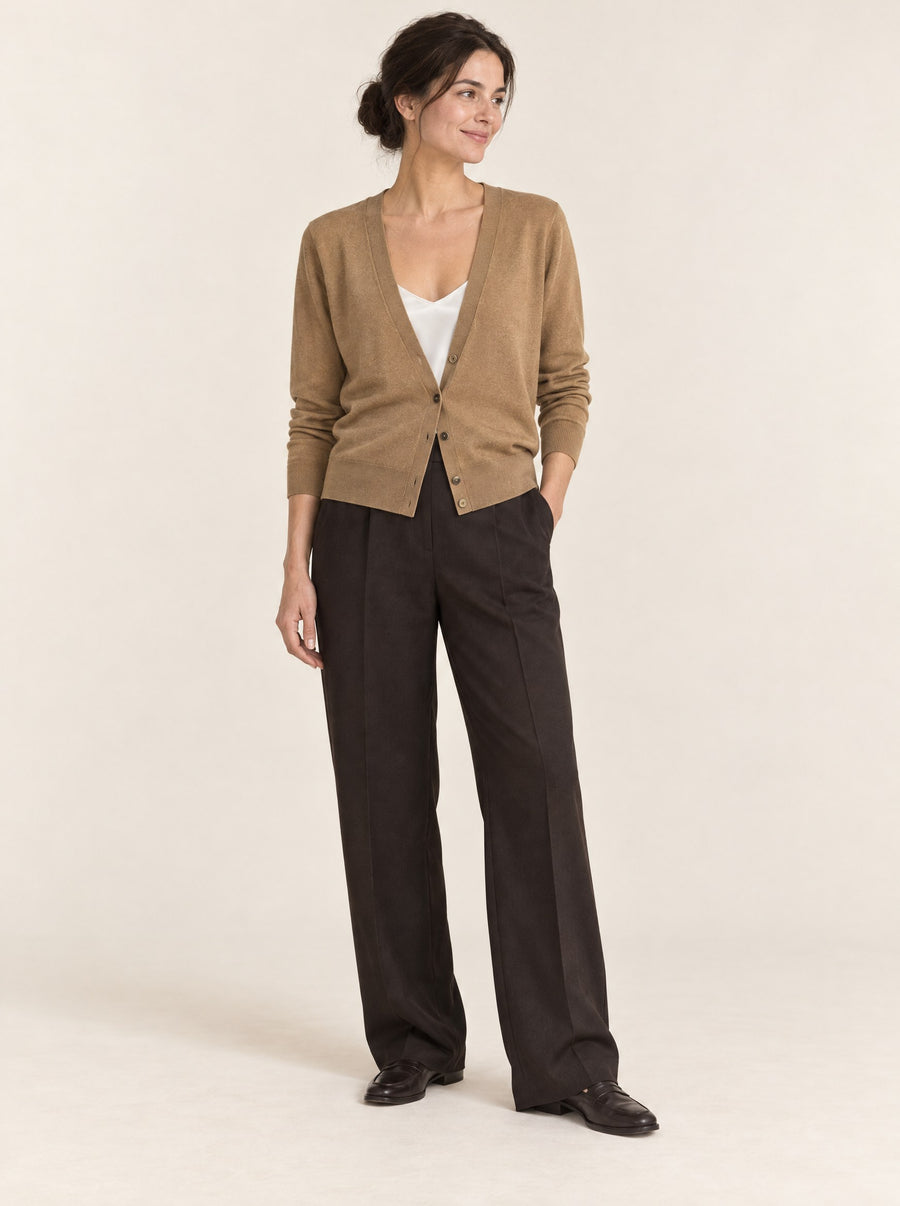 Camel V-neck cardigan over a white camisole, in the studio