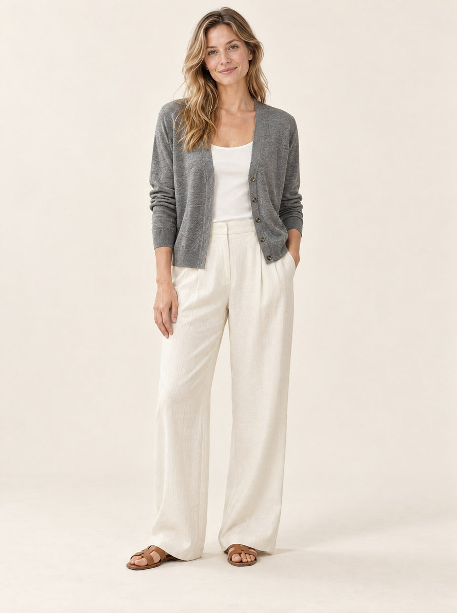 Grey V-neck cardigan worn open, in the studio