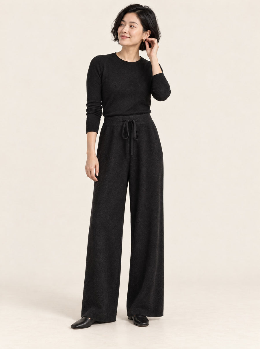 Black wide-leg knit wool trousers, full length in the studio