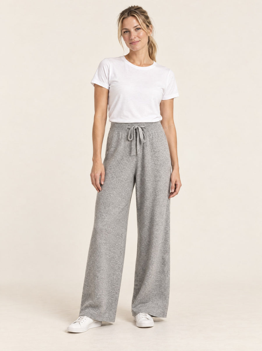 Light grey wide-leg knit wool trousers, full length in the studio